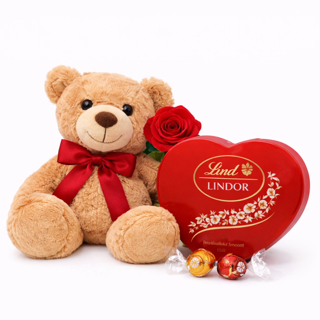 Teddy bear with a red ribbon, rose, and Lindor chocolate box on a white background